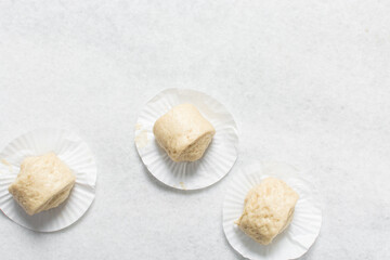 Overhead view of steamed bun dough on a white countertop, top view of mantou dough, process of making steamed milk buns