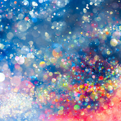 Rainbow of sparkling glitter creating mystical and vibrant spectrum of colors. Dreamy or magical shimmering particles glowing in a bokeh of lights. Ethereal aura with vivid colors abstract background.