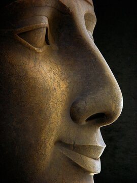 Detailed view of the stone face of a statue.