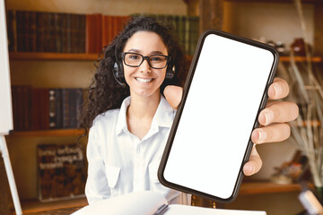 Happy For Success. Smiling woman wearing headphones, showing thumbs up gesture, enjoying e-learning...