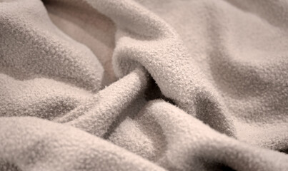 Light soft smooth bouclé teddy brushed fleece sherpa fabric. Nude beige brown white wool background. Warm cozy blanket, carpet. Pale floor covering. Hoodie material lining. Wave line crumpled swirl.
