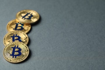 Cryptocurrency. Golden bitcoins on grey background, closeup. Space for text