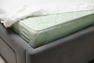 Comfortable bed with new soft mattress indoors, closeup