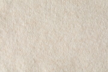 Texture of beige wool fabric as background, top view