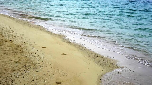 Gentle waves washing ashore on a windy beach in Chatan, Okinawa