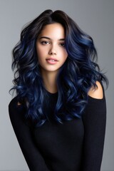 Naklejka premium A woman with long blue hair is posing for a photo