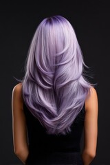 Naklejka premium A woman with long purple hair is standing in front of a black background