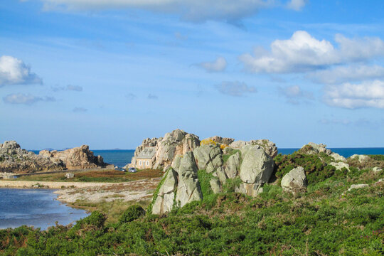 Perros Guirec, Brittany, France. Rocks at pink granite coast, Cote de granite Rose french natural sight at seaside. Granite red rock formations at sea cost of France and sea waves