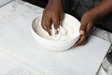 Overhead view of steamed bun dough being mixed on a white background, top view of mantou dough...