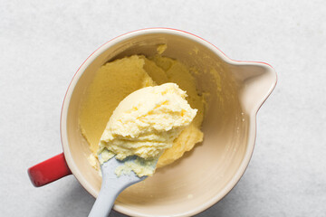 Top view of Creamed butter and sugar on a spatula, the process of making a cake or cookie