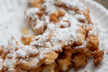 closeup of funnel cake covered in powdered sugar