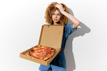 Surprised woman with curly hair holding an open pizza box, expressing shock perfect for food related themes and unhealthy eating concepts