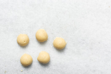 Top view of vanilla sugar cookie dough on a parchment lined baking sheet, process of making cut out vanilla sugar cookies