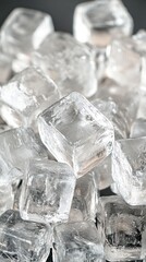 Obraz premium Pile of clear ice cubes on a dark surface.