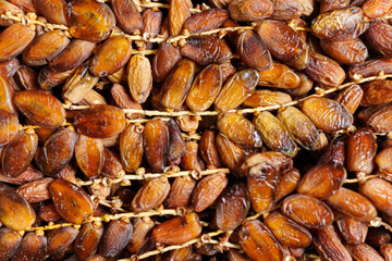 A tempting display of ripe dates presents a naturally sweet treat. The rich amber hues suggest a deep, concentrated flavor, showcasing nature's candy in perfect condition and form.