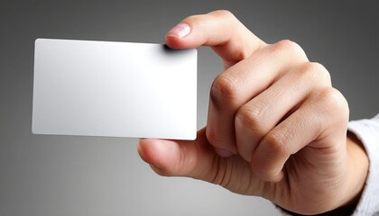 A hand is holding a blank white card, ready for customization or branding, against a neutral background.
