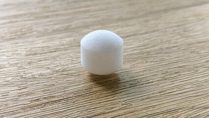 White naphthalene balls on blue background.