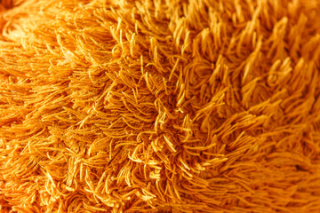 Golden-toned, fluffy texture captivates the eye with its inviting warmth and soft appearance, perfect for conveying comfort, abstract backgrounds, and cozy themes in design projects.