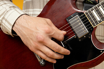 A man plays a beautiful guitar close-up