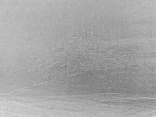 A close-up shot captures the intricate weave and subtle texture of a silver fabric, creating a versatile backdrop that suggests elegance and depth, ideal for various creative applications.