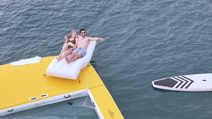 A young couple are enjoying seaside adventure aboard a yacht