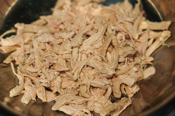 Elevated close-up showcasing tender, shredded poultry, ideal for culinary projects or highlighting protein-rich ingredients. Perfect for nutrition, cooking, or healthy eating contexts.