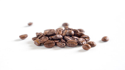 Coffee beans on white background. Pile of coffee beans. Close up image.