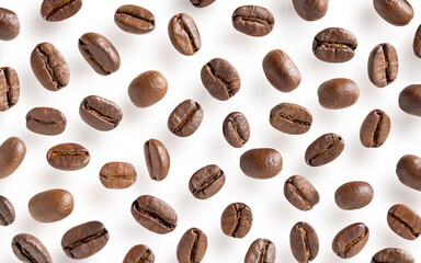 Roasted coffee beans. Scattered coffee beans on a white background with clipping paths. Close up image.