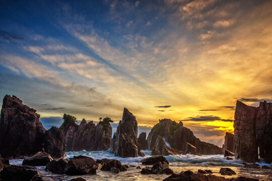 Stunning Gigi Hiu Beach at sunrise Dramatic Shark Teeth rock formations against a vibrant sky. Coastal landscape, travel, Indonesia, Lampung