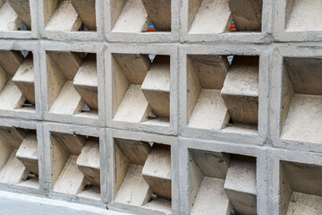 A geometric pattern, repeated architectural elements form an abstract wall design. The repetitive grid offers texture and visual depth, suited for backgrounds and modern aesthetics in design.