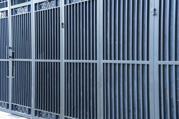 A close-up showcases a symmetrical array of metal bars forming a gate or barrier, with detailed...