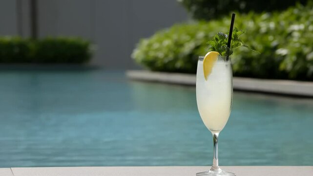 refreshing cocktail named quiet noise placed elegantly on table by poolside surrounded by lush greenery and