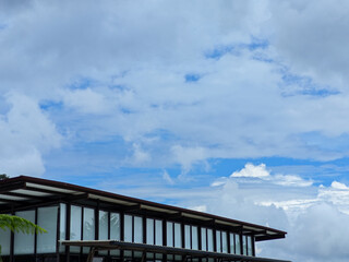 Fototapeta premium Modern architecture intersects with nature?s canvas under a bright cloudy sky, creating a scene of contemporary design and open space, ideal for lifestyle or architectural themes.