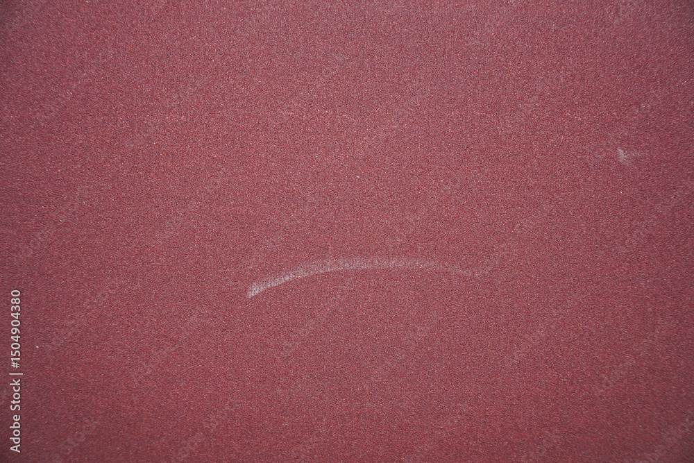 Fototapete detailed close-up showcasing a red, coarse texture with subtle tonal variations, perfect for backgro