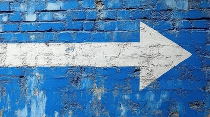 White arrow pointing right on blue brick wall