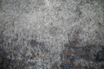 Abstract background showcases a textured, grey surface with subtle variations in tone, adding depth...
