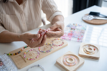 Senior mature older asian woman Art hobby handmade making beads jewellery accessories handcraft...