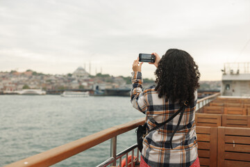 istanbul,Young woman tourist looking out at the beautiful summer sea,fotoğraf &ccedil;ekimi