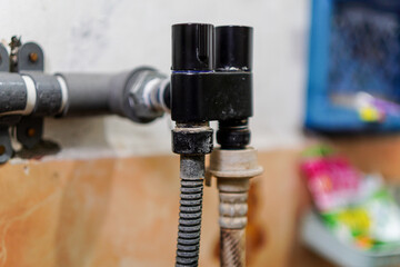 A close-up showcases plumbing with black fixtures and textured pipes against a neutral backdrop. Ideal for illustrating maintenance, repairs, or infrastructural design concepts with a clean style.