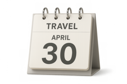 Desktop calendar displaying april 30th with the word travel on top, suggesting travel arrangements and planning
