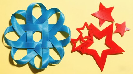 Minimalist craft composition: Blue satin ribbon woven geometric sculpture with red star ornaments on light yellow background. Delicate yet vibrant for festive decor, DIY tutorials, creative packaging 