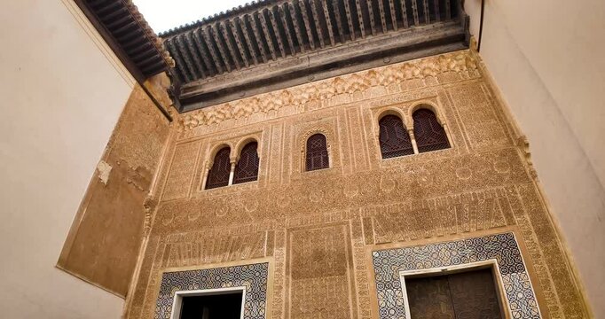 Panoramic and detail shot of the Comares facade facing the gallery of the Golden Room, marking the division between the public and private areas of the Alhambra monumental complex in Granada, Spain