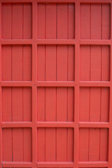 The wooden door panels are painted dark red.
