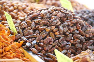 Sweet dates piled high at local market in the afternoon sun