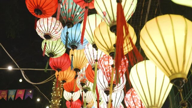 Silk lanterns glowing softly, casting warm light across narrow streets, highlighting cultural heritage of historic hoi an during magical evening ambiance