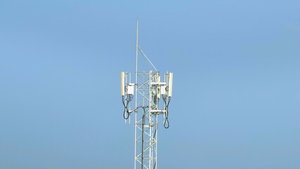 The drone captures the intricate design of a telecommunications tower, showcasing the modern technology behind wireless communication systems that connect millions of users across vast distances.
