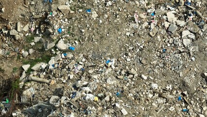 From above, the image showcases a heap of construction debris, including concrete waste,...