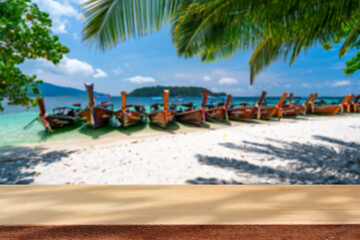 Wooden table with tropical beautiful white sand beach and blue sky background, Summer vacation concept and copy space
