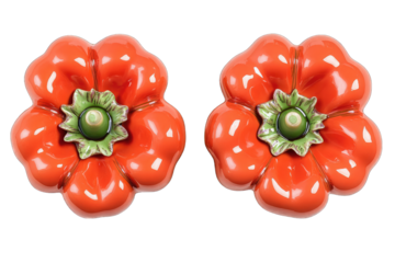 Pair of vibrant orange ceramic flower-shaped ornaments, glossy finish, detailed green center