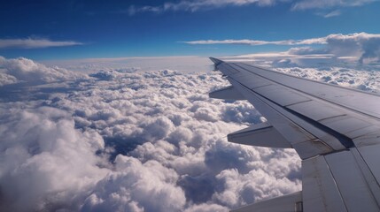 Obraz premium Flying above the clouds airplane wing view travel photography high altitude serene sky